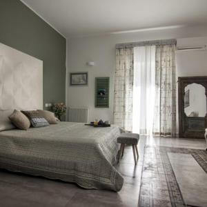 a bedroom with a large bed and a large window at Ad Hoc Rooms in Palermo