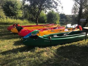 a group of kayaks lined up on the grass at Villa Bodiky in Bodíky