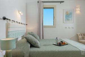 a bedroom with a bed with a table on it at Appartamento Botanico - SHERDENIA Luxury Apartments in Santa Marinella