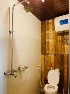 a bathroom with a toilet and a shower at Serengeti Villa in Arusha