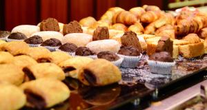 
a table filled with lots of different types of pastries at Hotel Tropical in San Antonio
