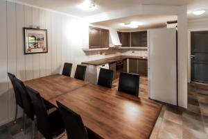 a kitchen with a wooden table and a refrigerator at Bakkebyvegen 1D in Trysil