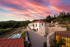 a villa with a swimming pool and a house at Portugal Active Armadas Lodge in Caminha