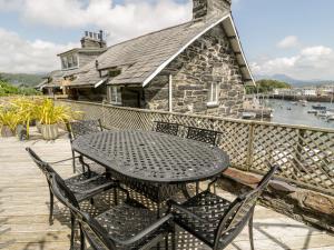 a black table and chairs on a deck at Harbour Suite in Porthmadog