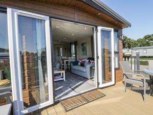 a screened in porch with sliding glass doors at Away Daze in Bridlington