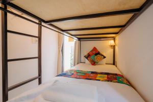 Postel nebo postele na pokoji v ubytování Wanderlust - Beach Side Hoi An