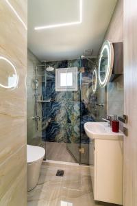 a bathroom with a shower and a sink at Ephantasy Living - Luxury home with roof garden in Kalamaki
