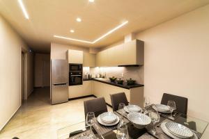 a kitchen and dining room with a table and chairs at Ephantasy Living - Luxury home with roof garden in Kalamaki Heraklion