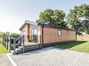 a tiny house with a porch and a deck at Brighter Daze in Bridlington