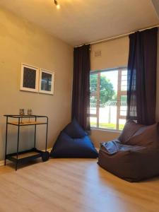 a living room with a couch and a window at African Cycad Holiday Home in Durban