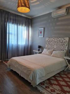 een slaapkamer met een groot bed en een raam bij African Cycad Holiday Home in Durban