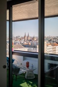a view of a city from a window at Skyflats Vienna - Rooftop Apartments in Vienna