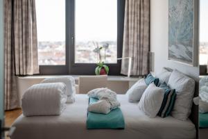 a white couch with pillows on it in a living room at Skyflats Vienna - Rooftop Apartments in Vienna