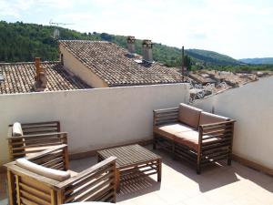 einen Balkon mit Stühlen und Blick auf ein Dach in der Unterkunft La miellerie de Léone in Riez