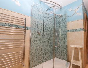 a bathroom with a glass shower with a toilet at Solton Manor in Dover