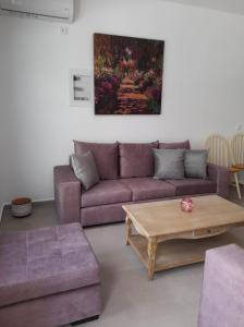 a living room with a couch and a coffee table at Cosy in Kardamaina