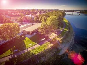 an aerial view of a building next to the water at WELTRAD Am Fluß Restaurant & Quartier in Schönebeck