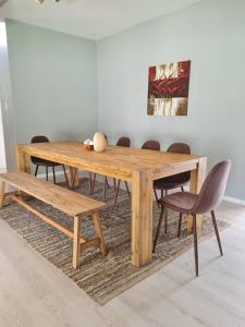 a wooden dining table and bench in a room at African Cycad Holiday Home in Durban