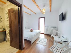 a bedroom with a bed and a desk and a television at Domeniul Acasa in Vadu Izei Maramu in Vadu Izei
