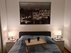 ein Schlafzimmer mit einem Bett und einem Tisch darauf in der Unterkunft Appartement avec rez de jardin à Disneyland in Montévrain