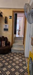 a living room with a staircase and a room with a couch at Exclusive Dependance in Palermo