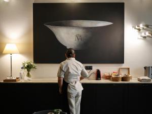 a man standing in a kitchen preparing food at La Pileta in Vejer de la Frontera