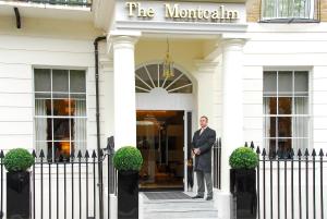 a man standing in the doorway of a white building at The Montcalm Marble Arch in London