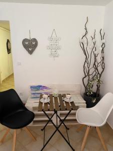 a table and two chairs in a room at Room Julija in Žirovnica