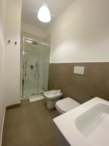 a bathroom with a shower and a toilet and a sink at AEROPORTO KATANÈ ROOMS in Catania