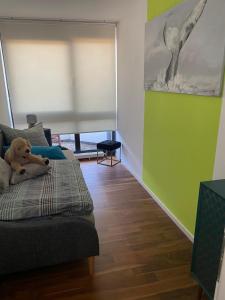 a teddy bear sitting on a bed in a room at Luxusferienwohnung im Herzen der Altstadt von Koblenz in Koblenz