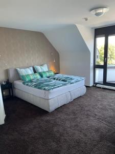 a large bed in a room with a window at Luxusferienwohnung im Herzen der Altstadt von Koblenz in Koblenz