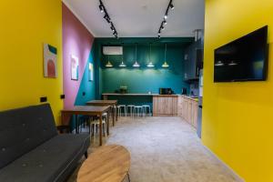 a restaurant with colorful walls and tables and chairs at DOMA HOSTEL in Almaty