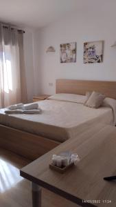 a bedroom with a large bed with two candles on it at B&B Troisi in Racalmuto