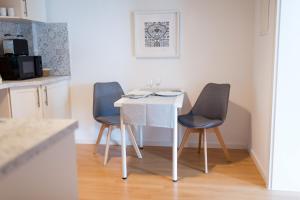 cocina con mesa blanca y 2 sillas en Apartment Falkenstein, en Königstein im Taunus