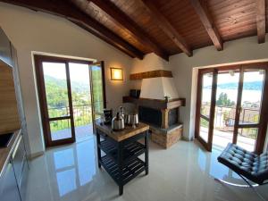 a living room with a fireplace and a table at Penthouse Andrea in Meina
