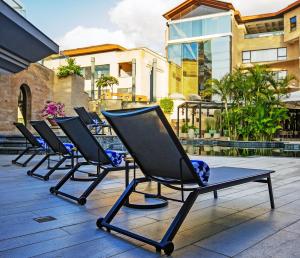 a row of chairs sitting on a patio at Tribe Hotel, Nairobi, a Member of Design Hotels in Nairobi