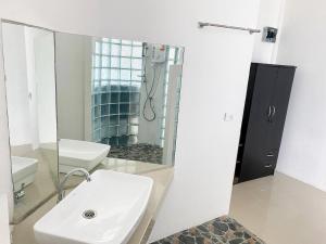 a white bathroom with a sink and a mirror at Pi3 Beach Resort in Lamai