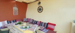 ein Zimmer mit einem Tisch, einem Sofa und einer Uhr in der Unterkunft Stavlos Country House in Arkasa