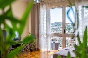 uma sala de estar com uma grande janela com vista em My Place in Funchal by Madeira Sun Travel no Funchal