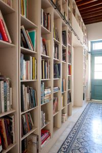 a hallway with bookshelves filled with books at MeMeraki Artist Residency in Limassol