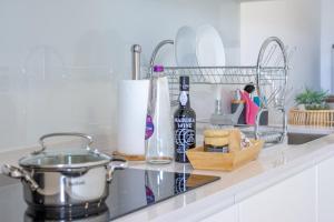 a kitchen counter with a sink with a pot and bread at Casa de Sao Tiago 1 in Funchal +33 photos