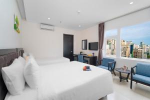 a hotel room with two beds and a window at Golden Star Hotel & Apartment by THG in Da Nang