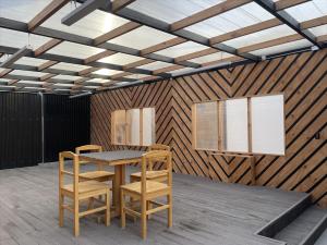 a dining room with a table and two chairs at Hotel Big Sur in Puerto Natales