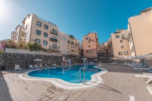 a swimming pool in the middle of some buildings at La sonada bright penthouse with views in Callao Salvaje