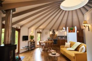 a living room with a couch and a table at Woodpecker Treehouse in Dittisham