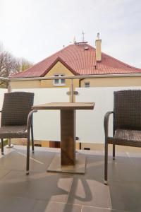 two chairs and a table on a patio at visit baltic - Villa Julia Studio Mola in Świnoujście