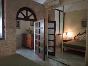 a bedroom with a mirror and a bed and a dresser at Appartamento Centrale in Molfetta