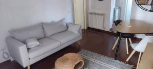 un soggiorno con divano bianco e tavolo di La Tana di Margherita a Perugia