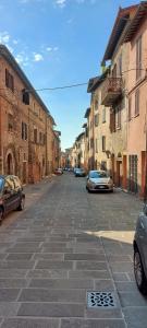 an empty street with parked cars in a city at La Tana di Margherita in Perugia