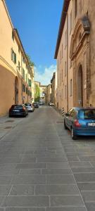 a street with cars parked on the side of a building at La Tana di Margherita in Perugia